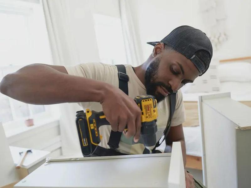Assembling a flat-pack cabinet with a cordless drill